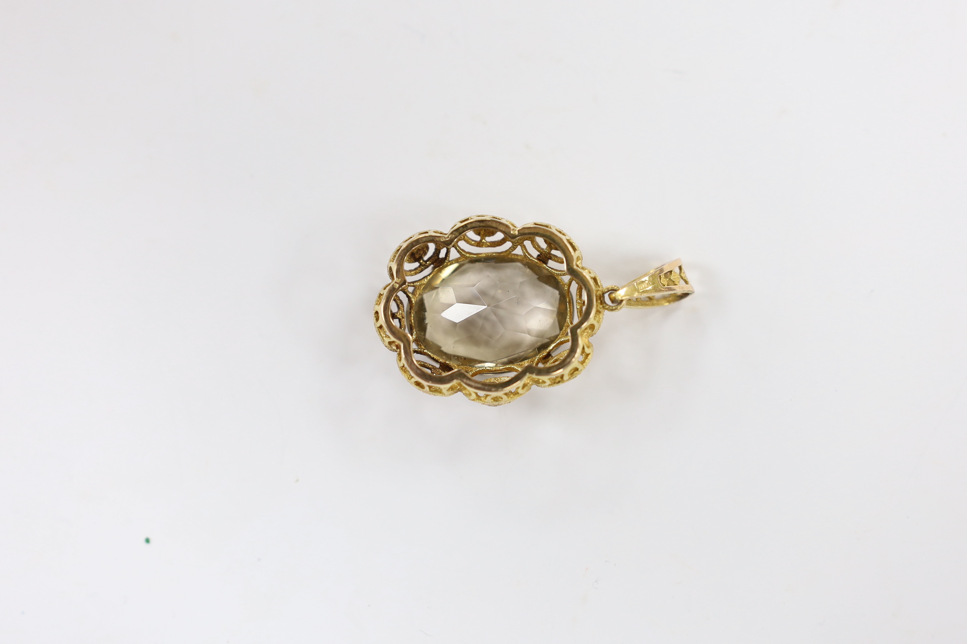 A 9ct gold and single stone oval cut pale smoky quartz set pendant, 50mm, gross weight 12.7 grams.